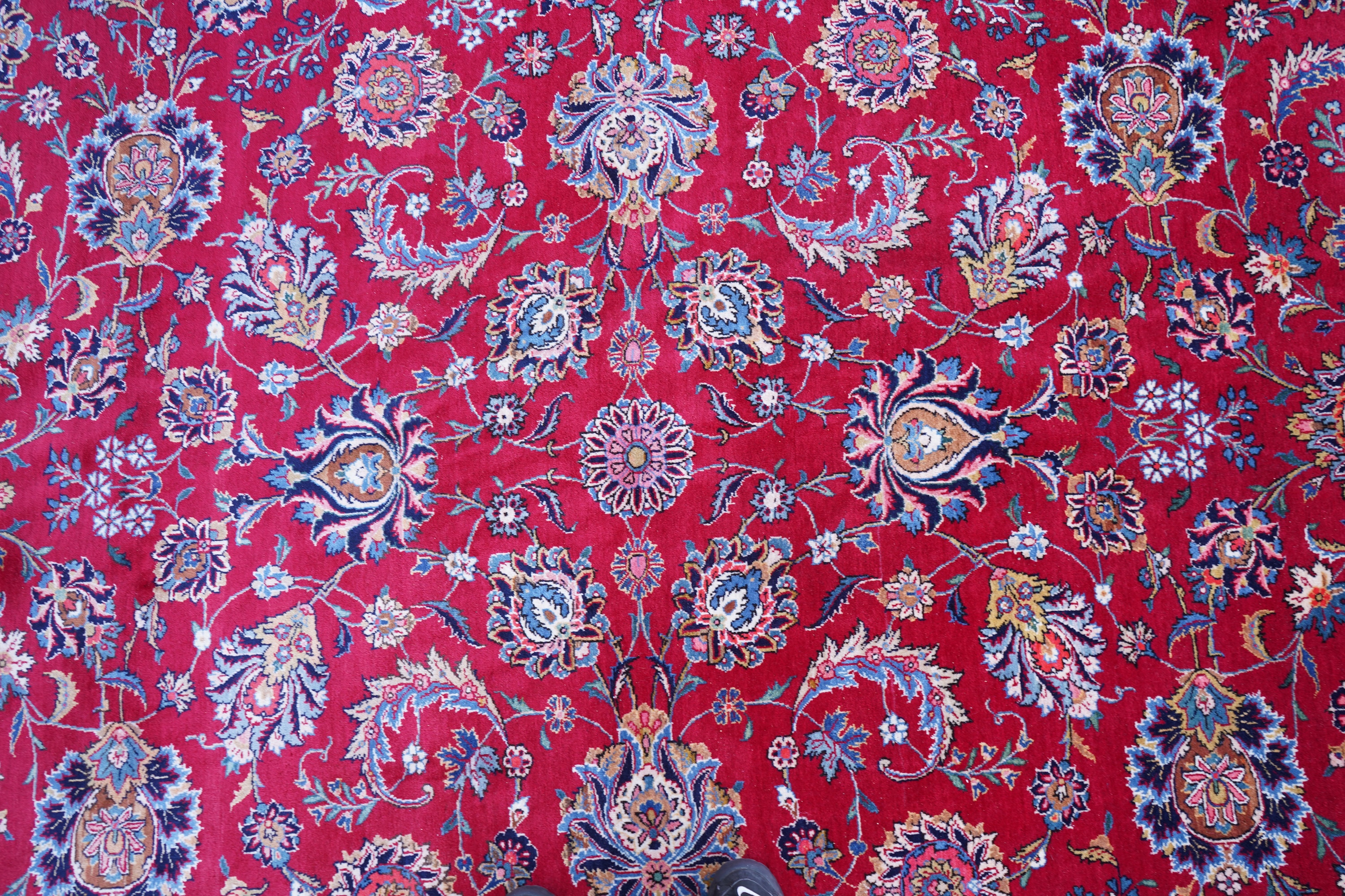 A Kashan burgundy ground carpet